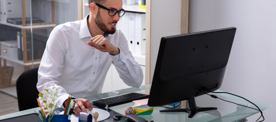 Businessman sitting at desk behind computer