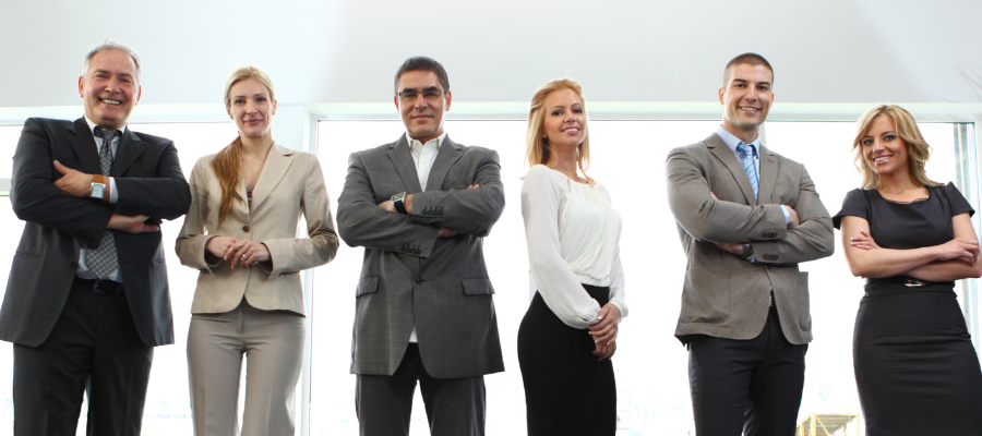 Businessmen and women standing in a line.